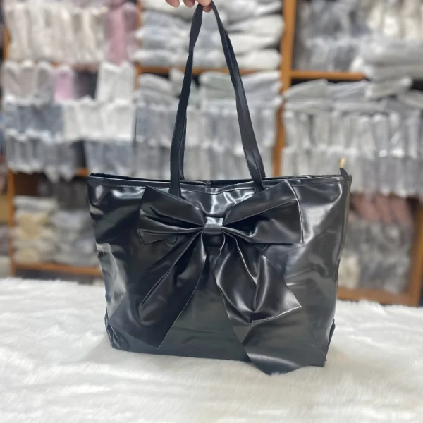 Large-capacity bow tote bag made of PU leather, fashionable design for daily use in black.