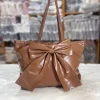 Large-capacity bow tote bag made of PU leather, fashionable design for daily use in brown.