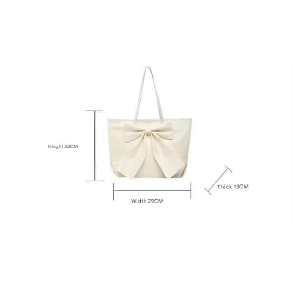 Large-capacity bow tote bag made of PU leather, fashionable design for daily use in white.
