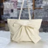 Large-capacity bow tote bag made of PU leather, fashionable design for daily use in white.