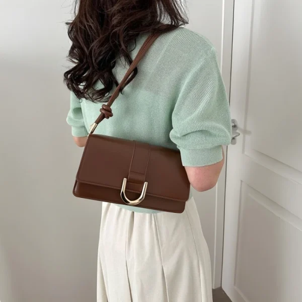 "Brown PU leather casual shoulder bag with buckle flap design for everyday use outfit"