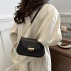 "PU leather commuter crossbody bag with metal lock for daily use in black outfit"