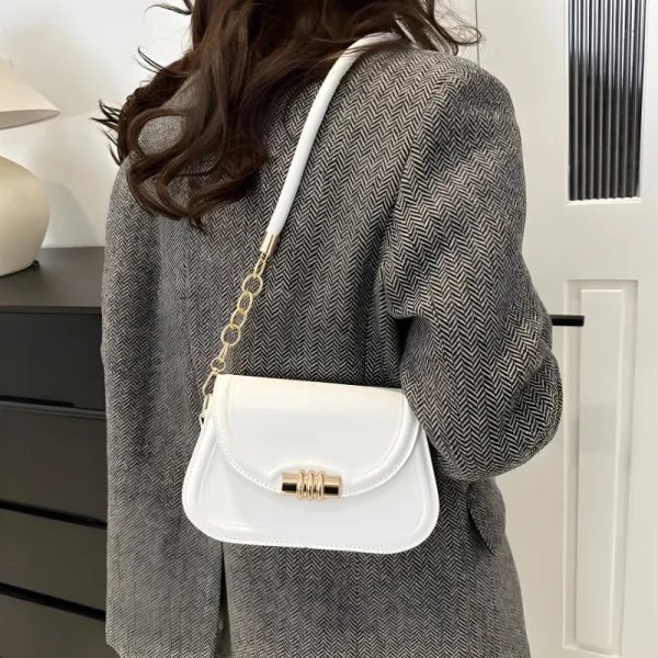 "PU leather commuter crossbody bag with metal lock for daily use in white outfit"