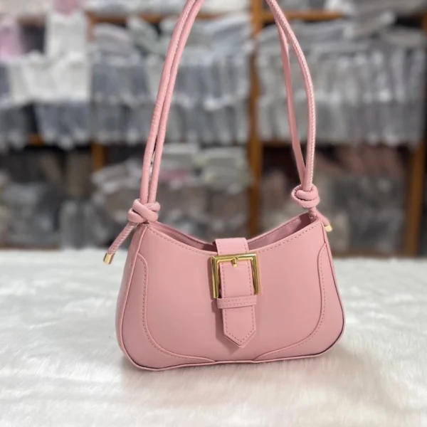 Compact women’s handbag in PU leather with buckle design for daily use, neutral pink color, perfect as shoulder or crossbody bag