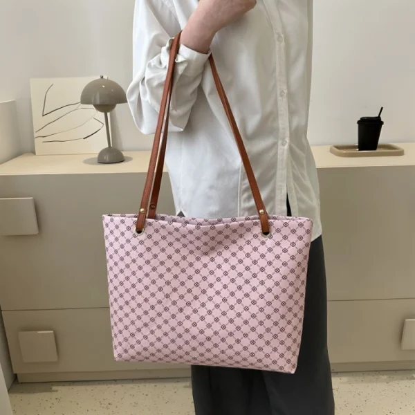 "Geometric pattern tote bag made of PU leather with waterproof build for daily use in pink outfit"
