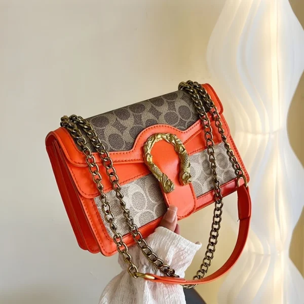 “Golden chain shoulder bag made of PU leather with premium fashion detailing for daily use in orange.”