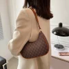 Imported ladies PU leather underarm handbag with zipper closure for daily use in brown outfit