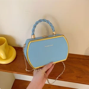 Korean-style women’s box handbag made of PU and PVC with twisted handle for daily use in blue