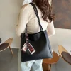 Large-capacity women PU leather tote bag with magnetic closure for daily use in black outfit
