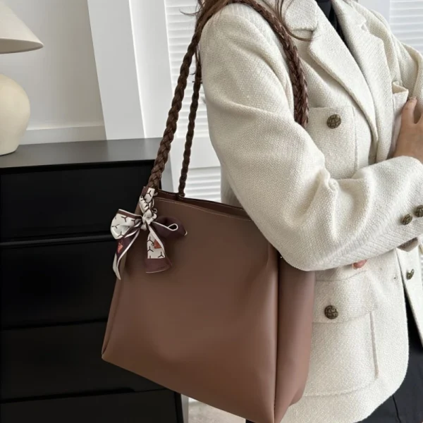 Large-capacity women PU leather tote bag with magnetic closure for daily use in brown outfit