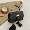 Luxury shoulder handbag made of PU leather with woven texture and gold hardware for casual fashion use in black.