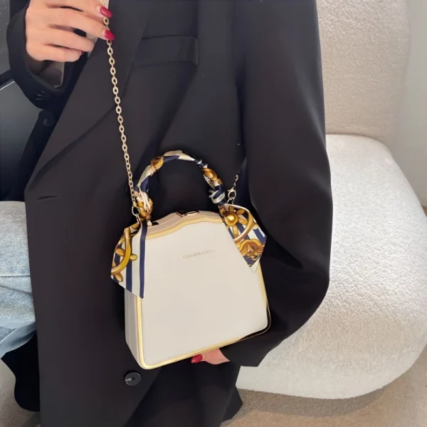 Luxury women’s box handbag made of PU leather with scarf-wrapped handle for daily fashion use in white outfit