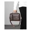 “Men's leather shoulder bag made of PU leather with multi-pocket design for business and travel use in dark brown outfit.”