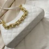 "Quilted baguette shoulder bag made of PU leather with chain detail for casual use in white"