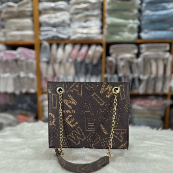 Urban women’s tote bag made of PU leather with letter print and chain handles for daily use in black.