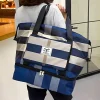 “Waterproof travel sports bag made of lightweight nylon with strong build for shopping and gym use in navy blue design.”