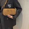 Women's crossbody bag made of PU leather with knot-style handle for trendy daily use in brown color outfit