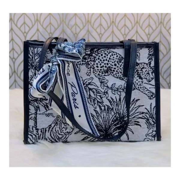 “Trendy women’s shoulder bag made of cloth with parrot-themed artistic design for casual outings in black parrot color"