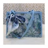 “Trendy women’s shoulder bag made of cloth with stylish floral design for casual outings in blue”