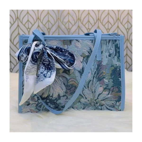 “Trendy women’s shoulder bag made of cloth with stylish floral design for casual outings in blue”