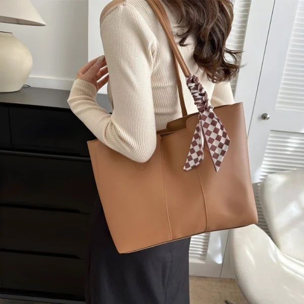 Women’s PU leather tote bag with large capacity for everyday use in brown color outfit