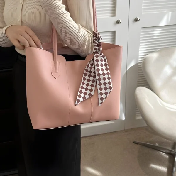 Women’s PU leather tote bag with large capacity for everyday use in soft pink color outfit