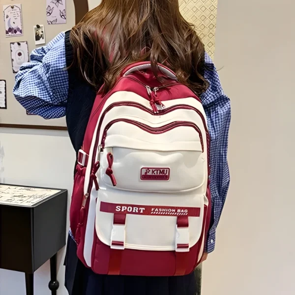 “Academy style school backpack made of Oxford and nylon with lightweight large capacity for daily school use in red outfit.”