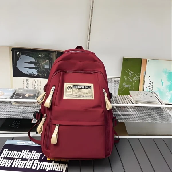 "Aesthetic large capacity polyester backpack with multi-pocket functional design for daily use in red."