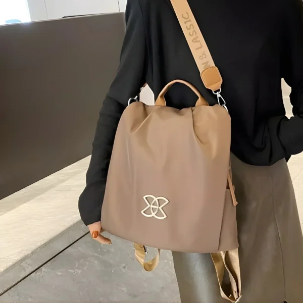 “Anti-theft women’s backpack and crossbody bag made of lightweight Oxford cloth for multi-purpose outdoor use in brown outfit.”