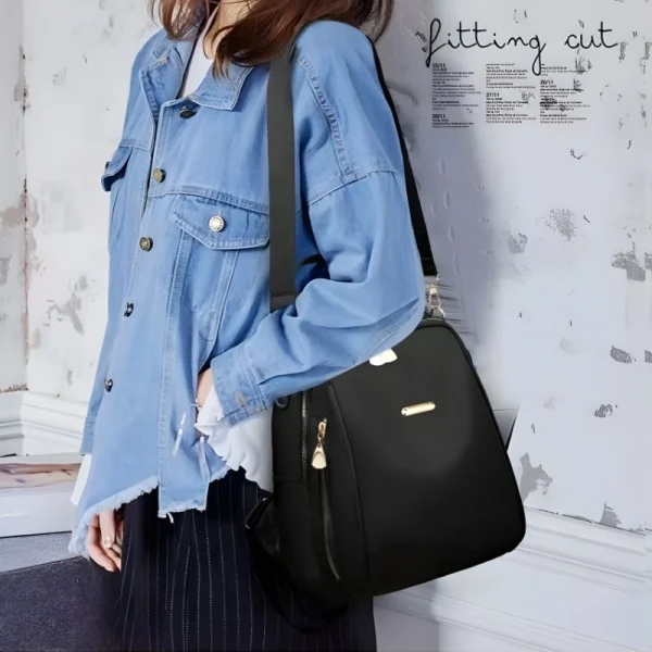 “Premium ladies handbag backpack made of nylon with anti-theft design for everyday multi-use in black outfit.”