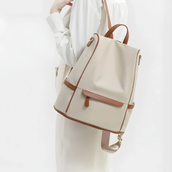 “Women waterproof Oxford backpack with anti-theft design and multi-pocket storage for travel and daily use in off white back.”